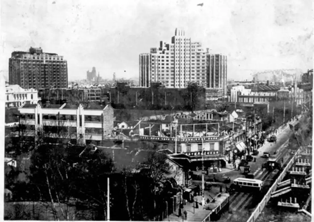 An old black-and-white view of Huaihai Road with the Jin Jiang Hotel buildings (Cathay Mansions and Grosvenor House).