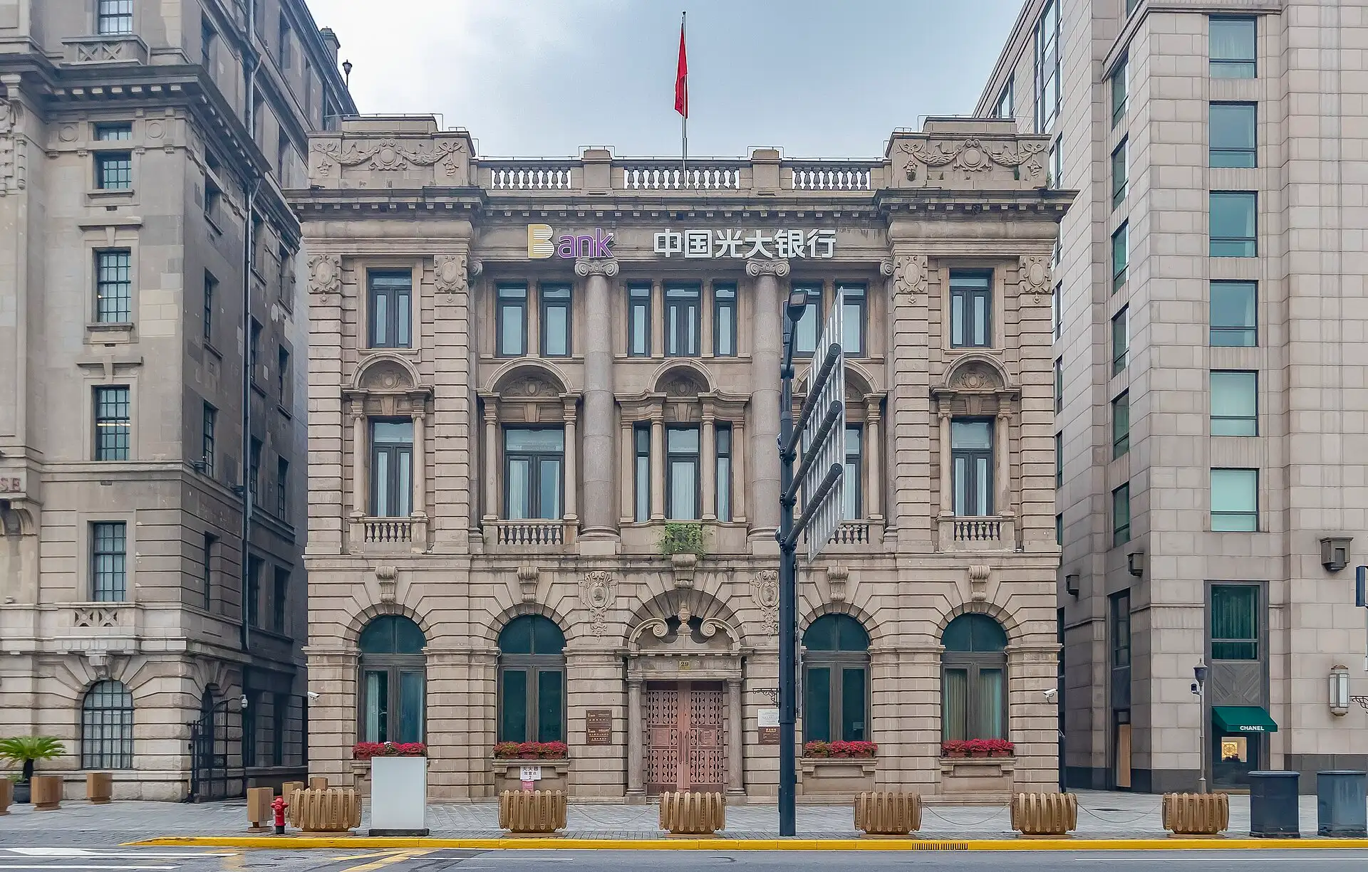 The former Banque de l'Indochine building, a stone façade with a central arched entrance and columns, on the Bund.