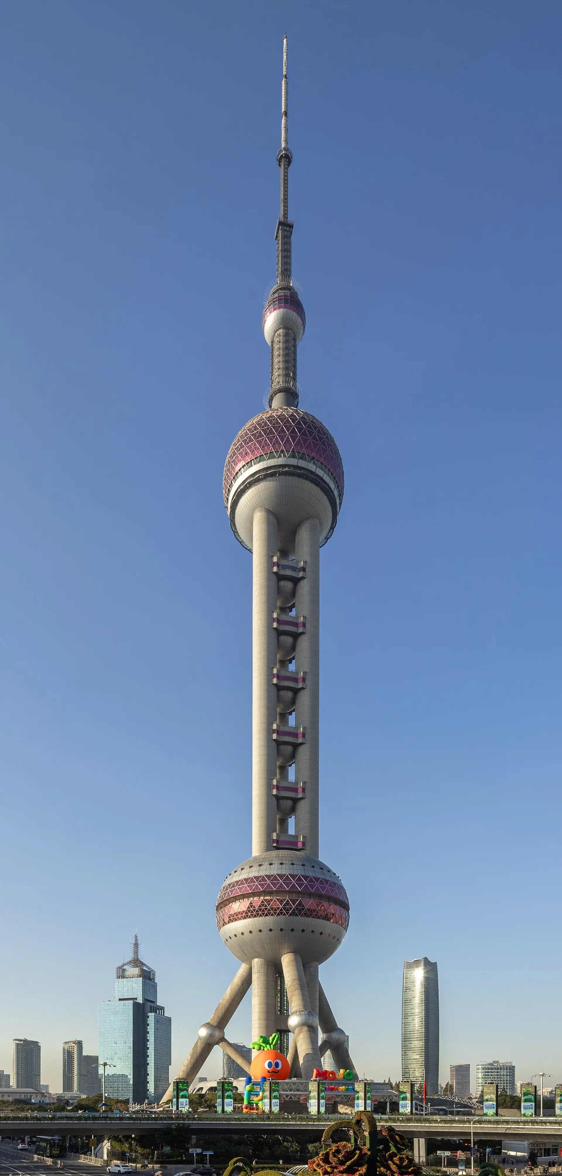 The Oriental Pearl Tower against a blue sky, with its spheres and spire.