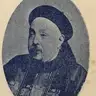 Oval portrait of an older man with a thin goatee in a Qing official cap and embroidered robe, with a Chinese caption above.