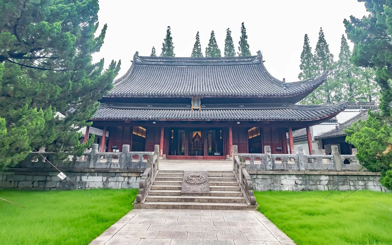 The main hall of Jiading Confucian Temple, with a broad tiled roof and stone steps between lawns.