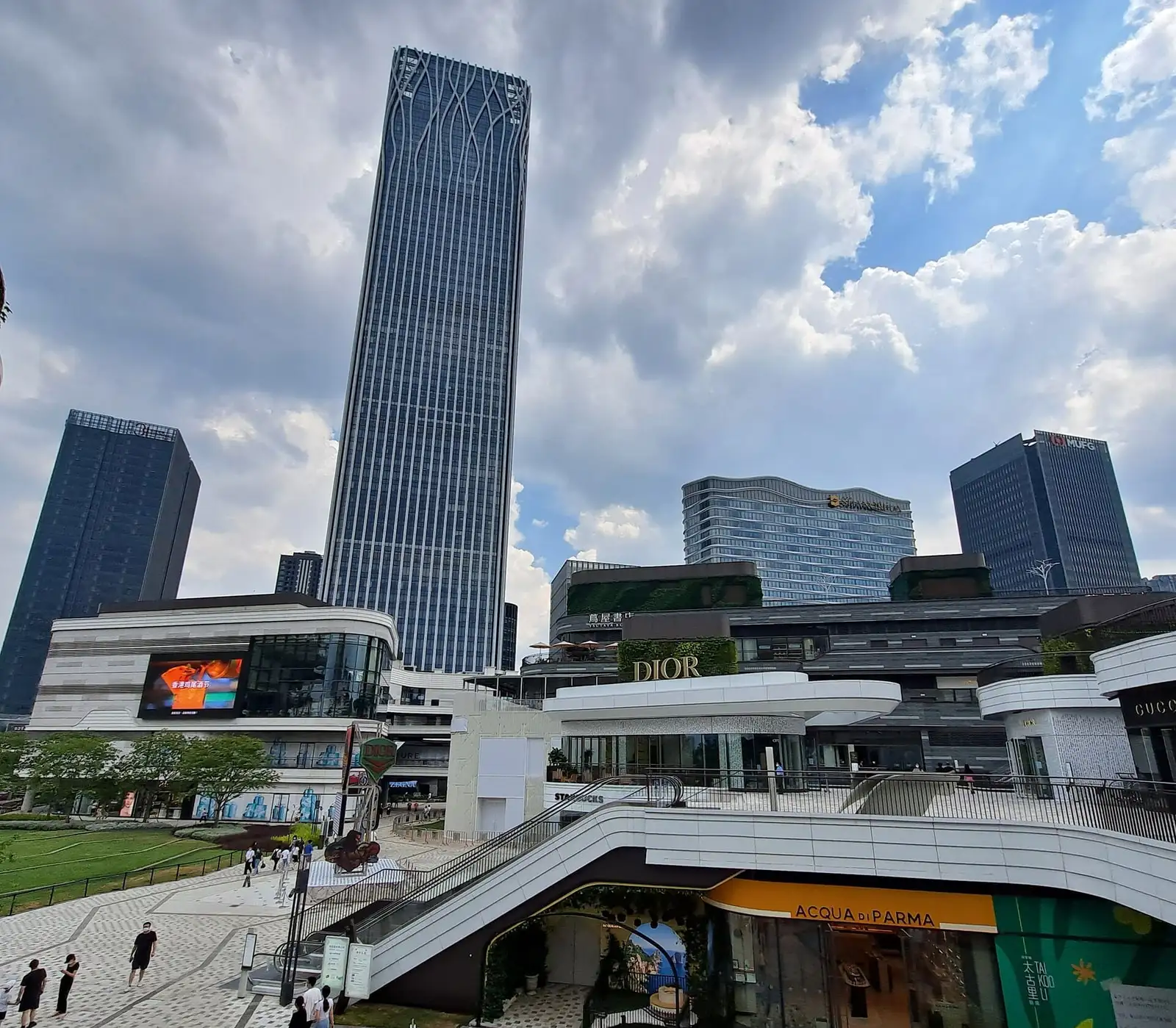 Outdoor terraces and stairs at Qiantan Taikoo Li, with shops and office towers beyond.