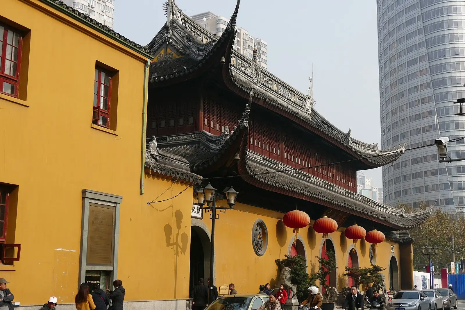 The yellow walls, red lanterns and dark tiled eaves of Jade Buddha Temple.