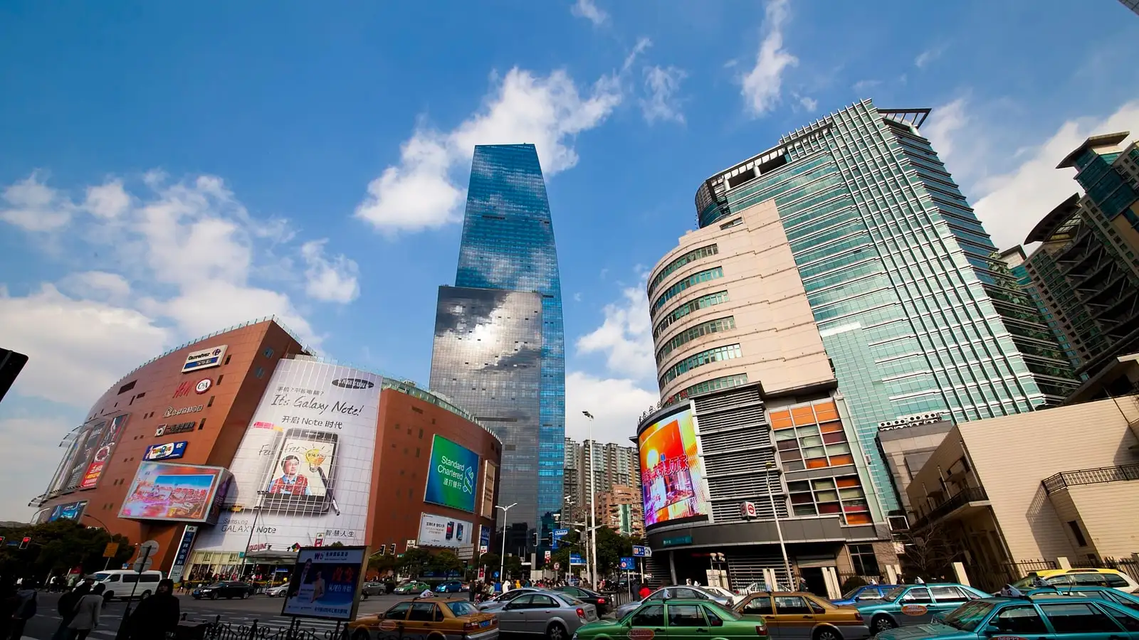 Shopping centres at Zhongshan Park, with tall glass buildings above busy streets.